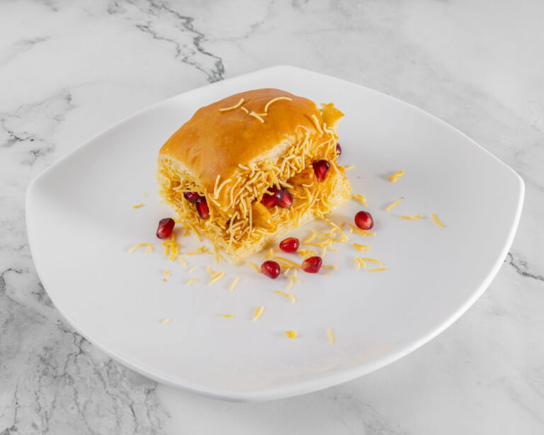 Dabeli: spicy mashed potato filling in soft pav bun with chutneys and sev