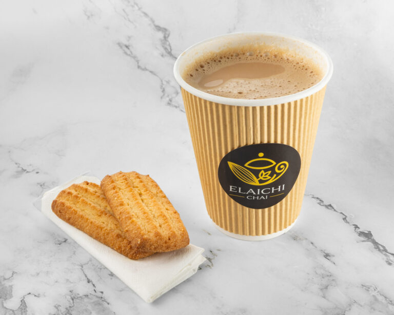 Indian chai tea served hot with biscuits on a plate