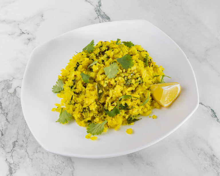 Indian poha made with flattened rice, peanuts, curry leaves and turmeric