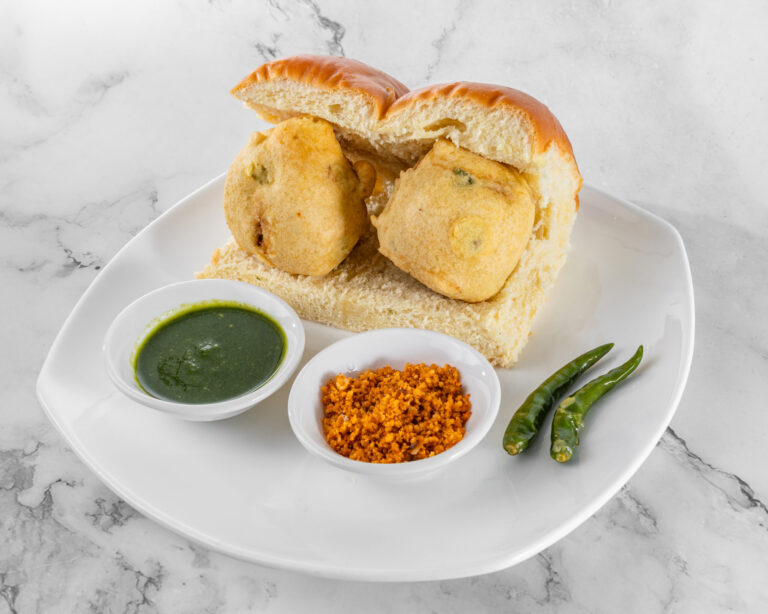 Mumbai street food vada pav: spicy potato fritter in soft bun with chutney